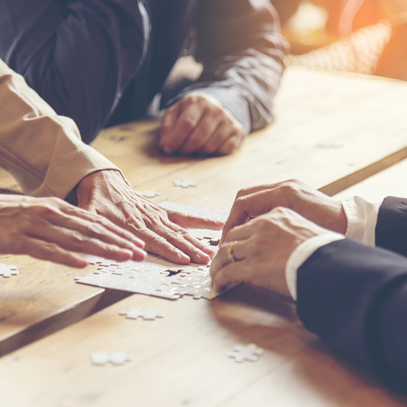 Implement improve puzzel solve connections together with synergy strategy team building organizing connection by trust communication. Hands of stakeholders business trust team holding jigsaw puzzle